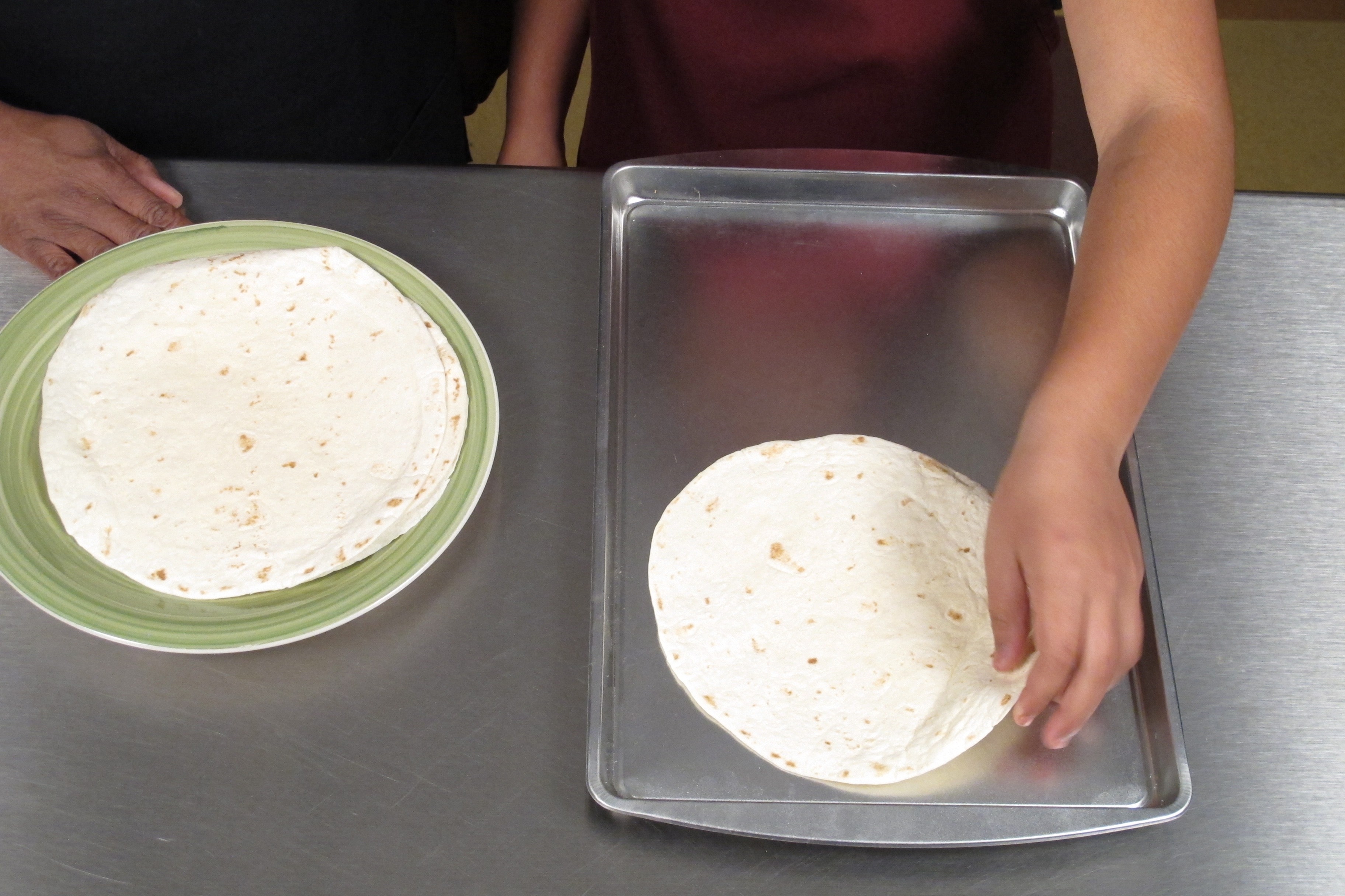 Place tortillas on two large baking sheets. Cook for 5 minutes and flip. Cook for 5 more minutes. Put to the side.